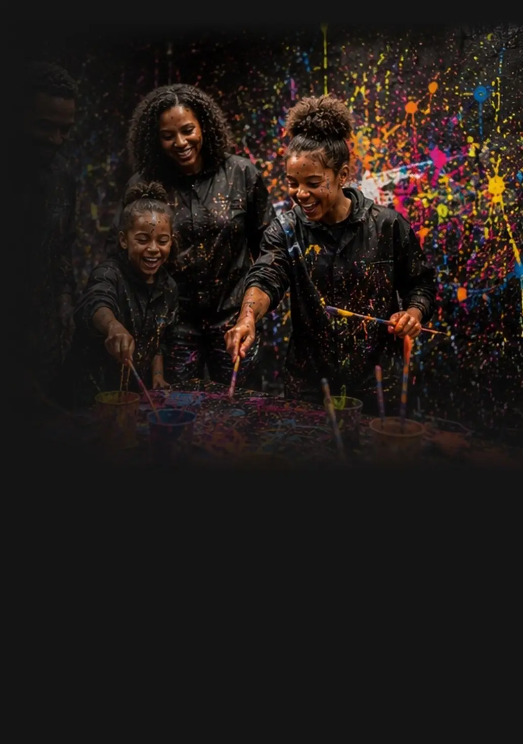 Family laughing while painting together
