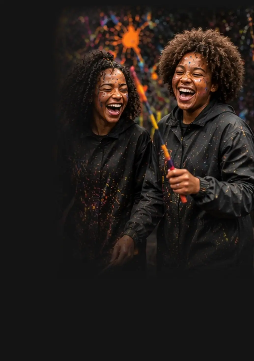 Two friends laughing with paintbrushes
