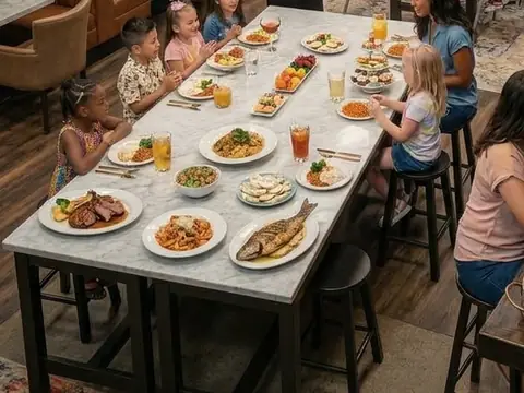 Kids sharing a long table full of colourful dishes